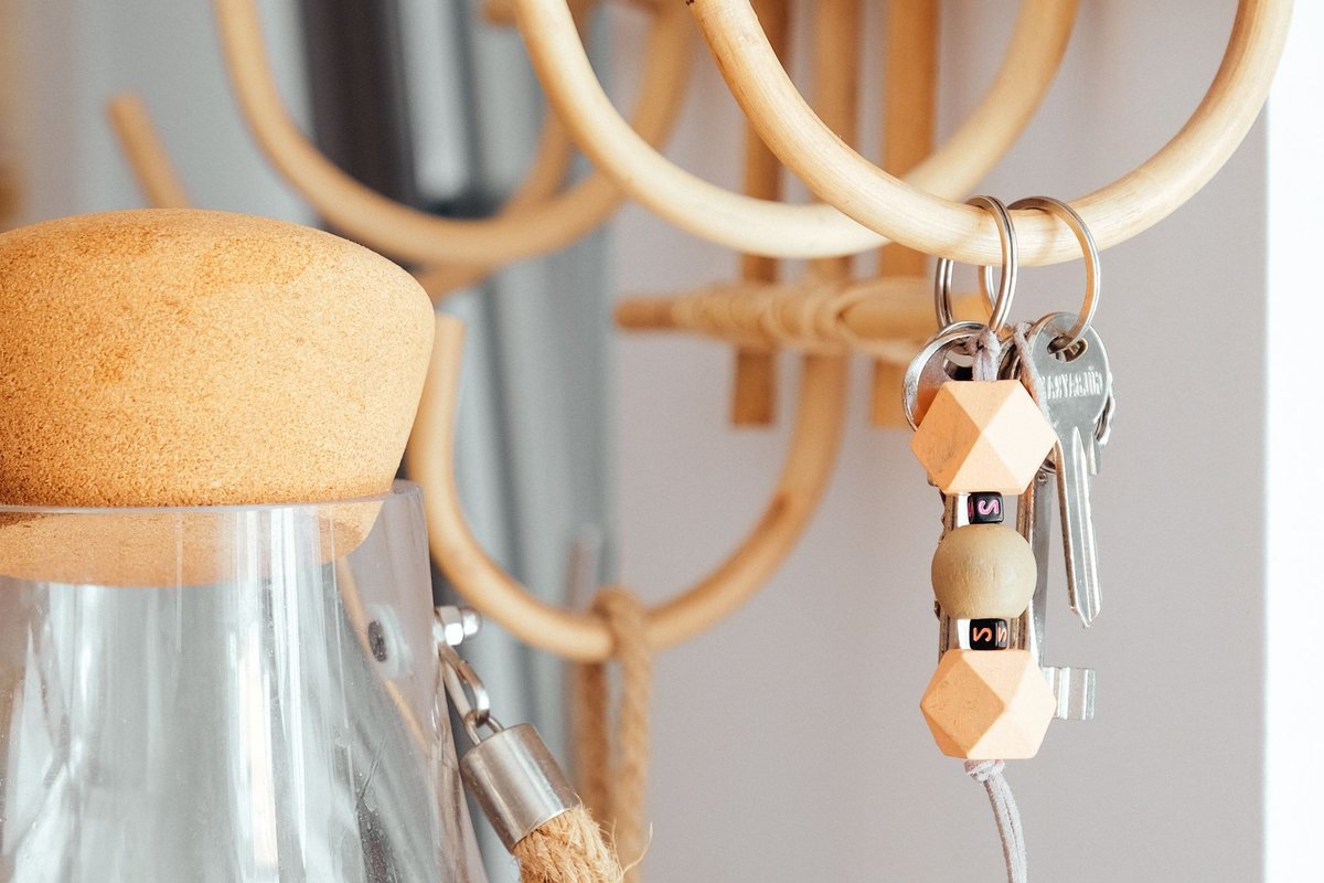 Keys hanging on a small wooden wall hook by the door
