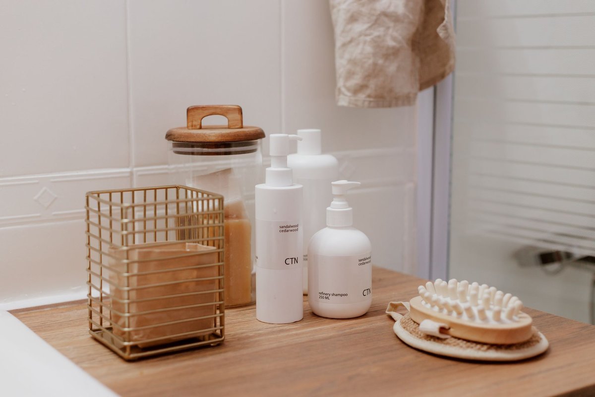 Toiletries and a wire basket organized in a bathroom corner
