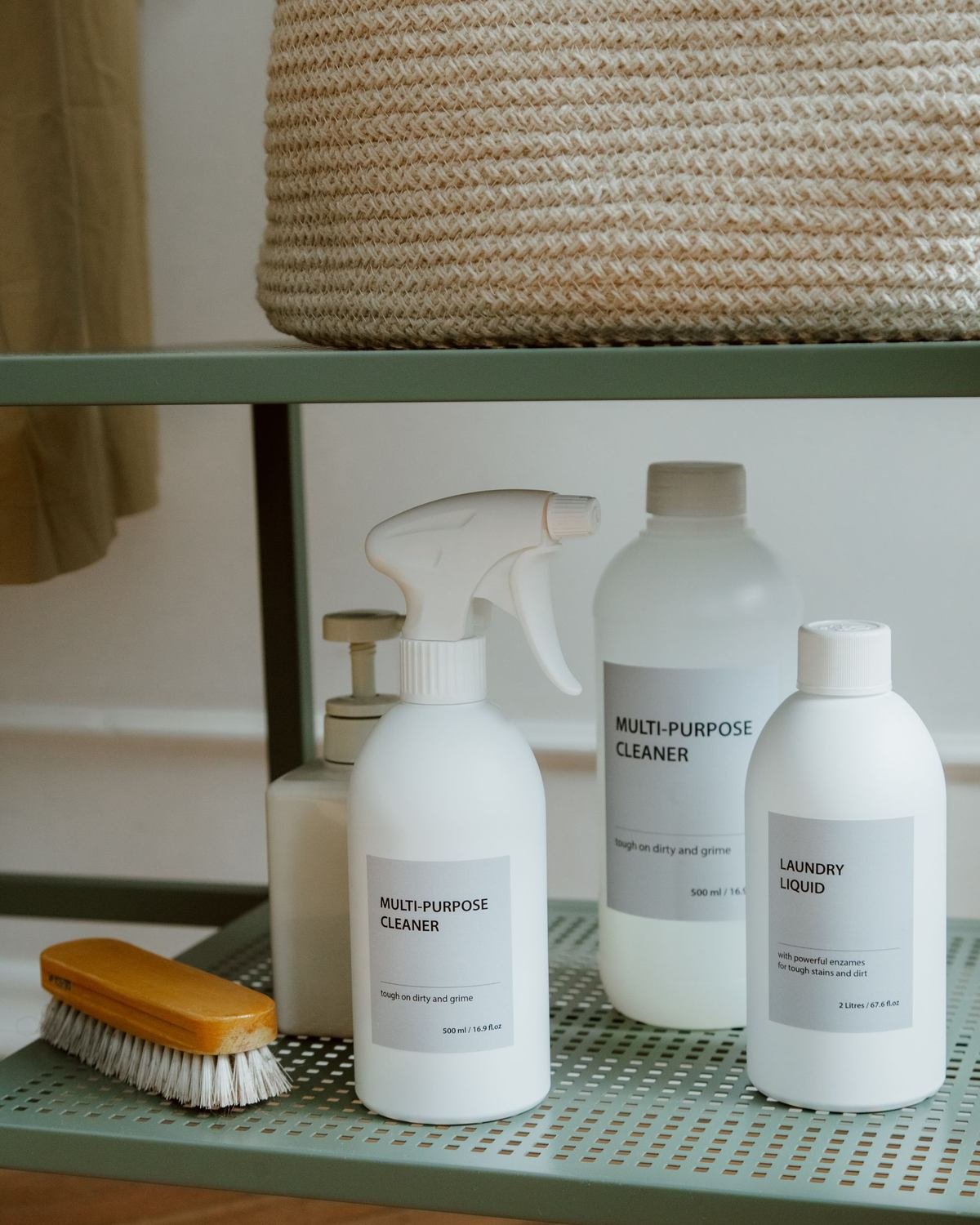 bottles of cleaning products and supplies arranged on a two-level metal shelf
