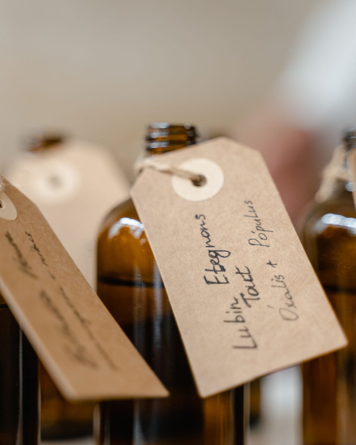 brown glass bottles with handwritten paper tags