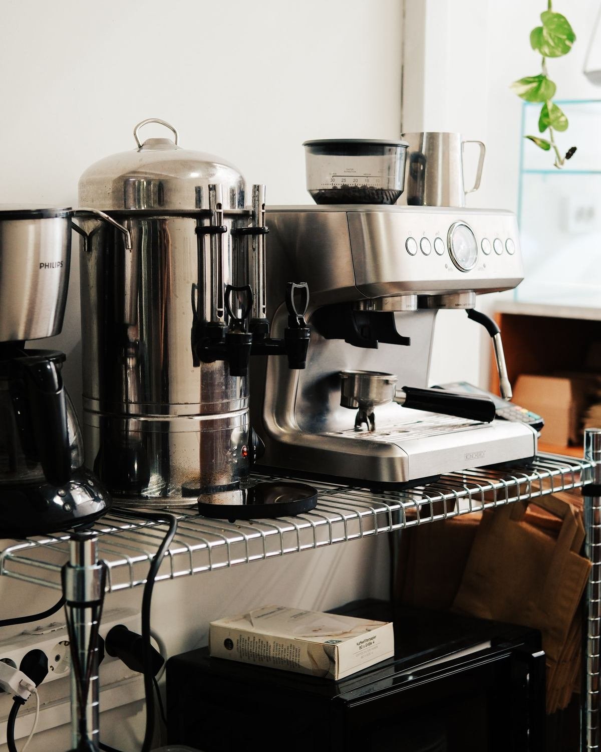 compact coffee station with an espresso machine and mugs on a kitchen counter