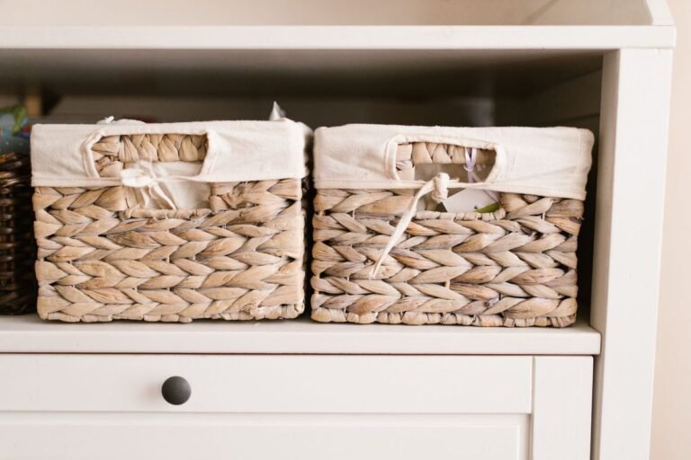 woven storage baskets on a white shelf for budget small space organization
