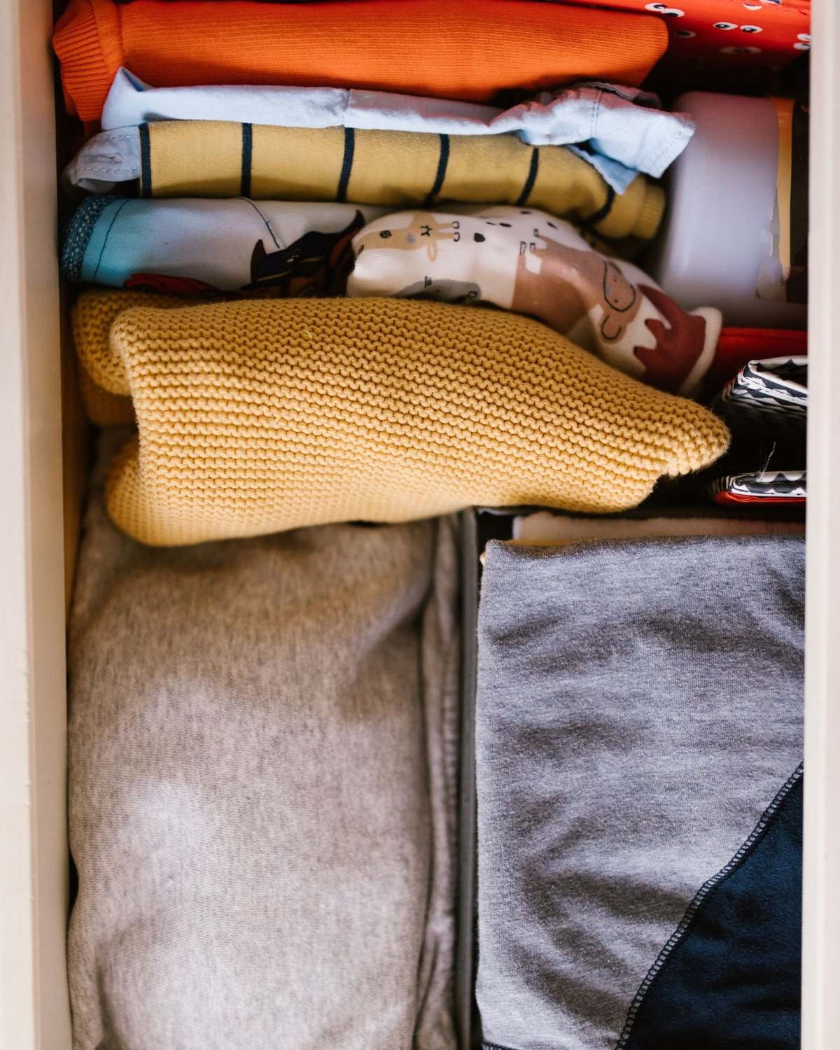 folded clothes neatly organized in a dresser drawer