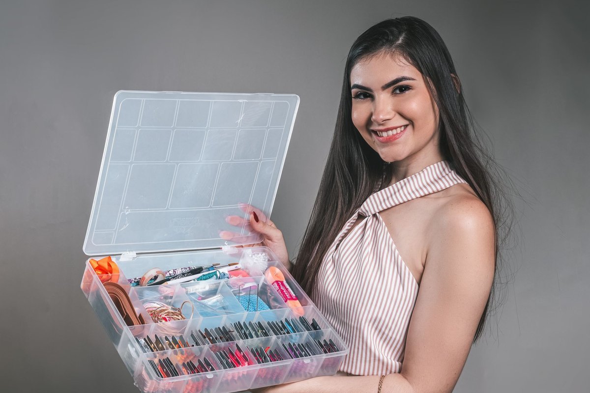 Woman holding a makeup organizer with small compartments