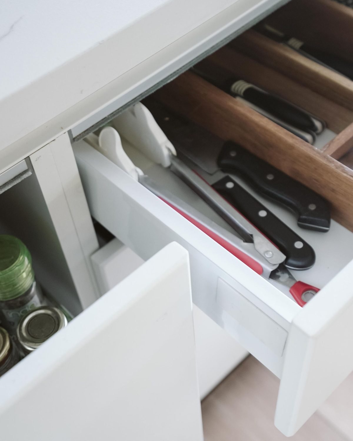 open kitchen drawer with knives and tools stored neatly inside