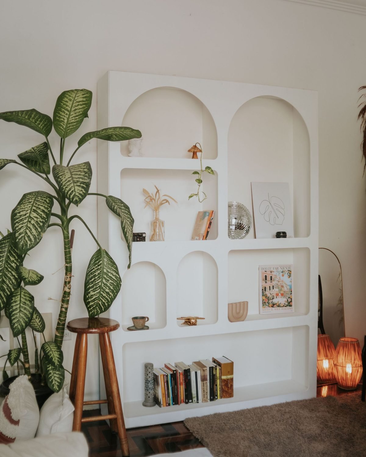 cozy organized living room with a bookshelf and plants