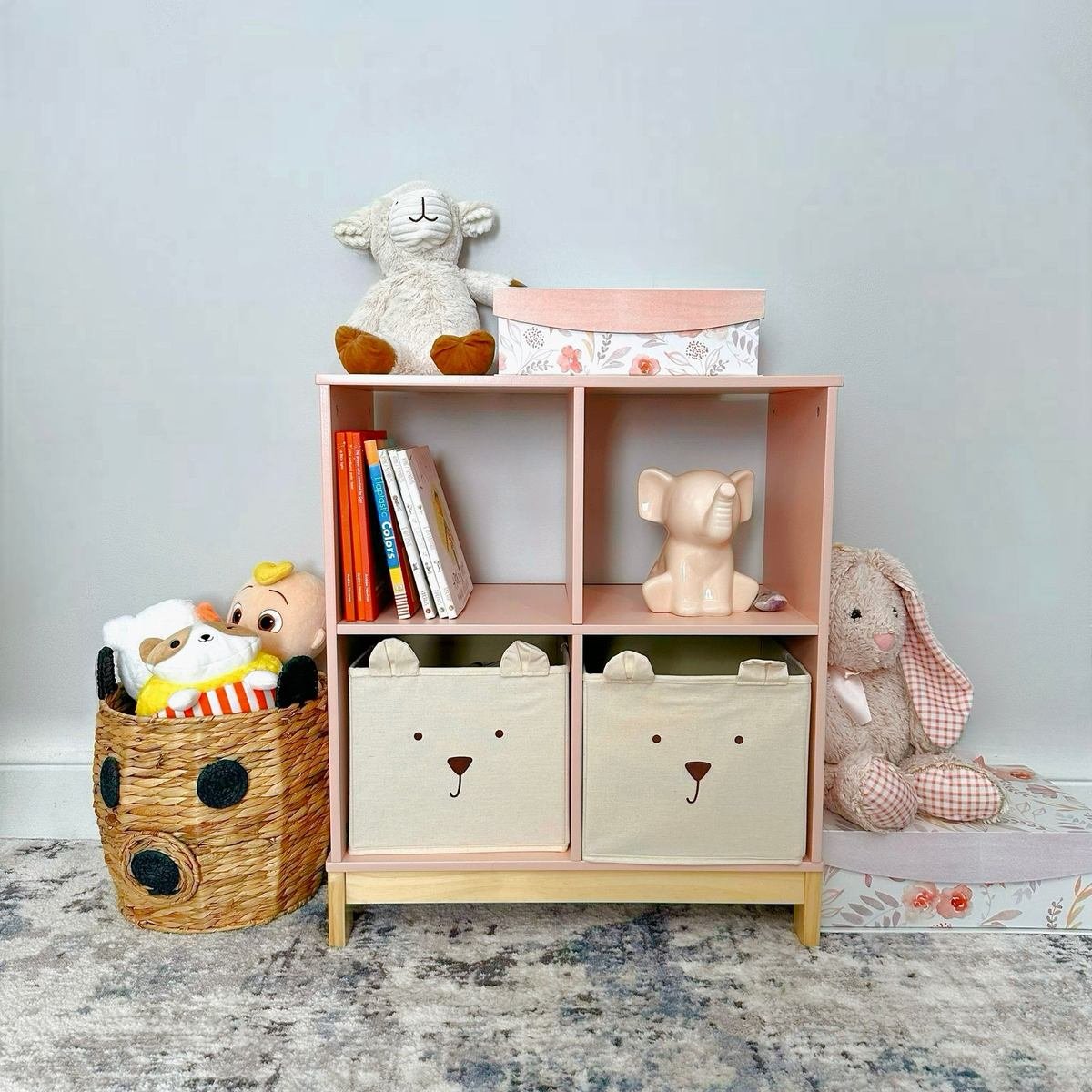 organized playroom shelf with plush toys, books and storage baskets