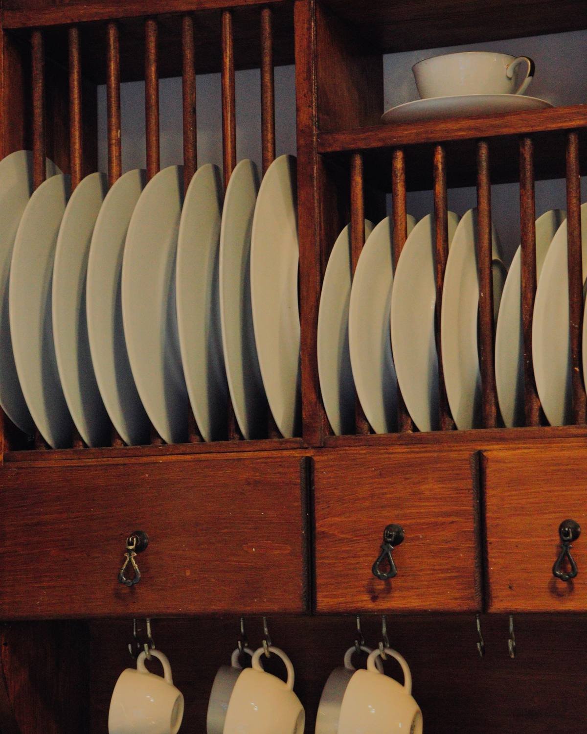 plates, cups and dishes stacked neatly around open kitchen drawers