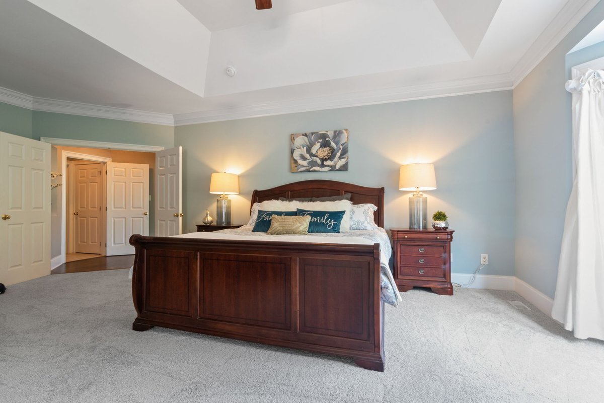 Bedroom with a raised wooden bed frame leaving space underneath