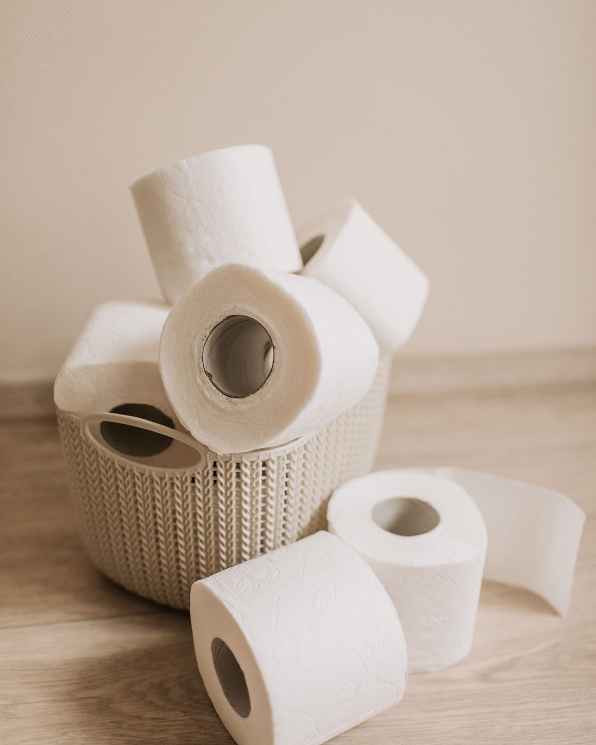 rolls of toilet paper piled on a light surface