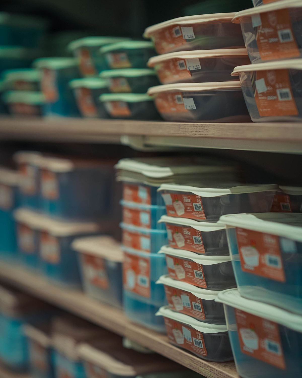 rows of neatly stacked food containers in various colors on store shelves