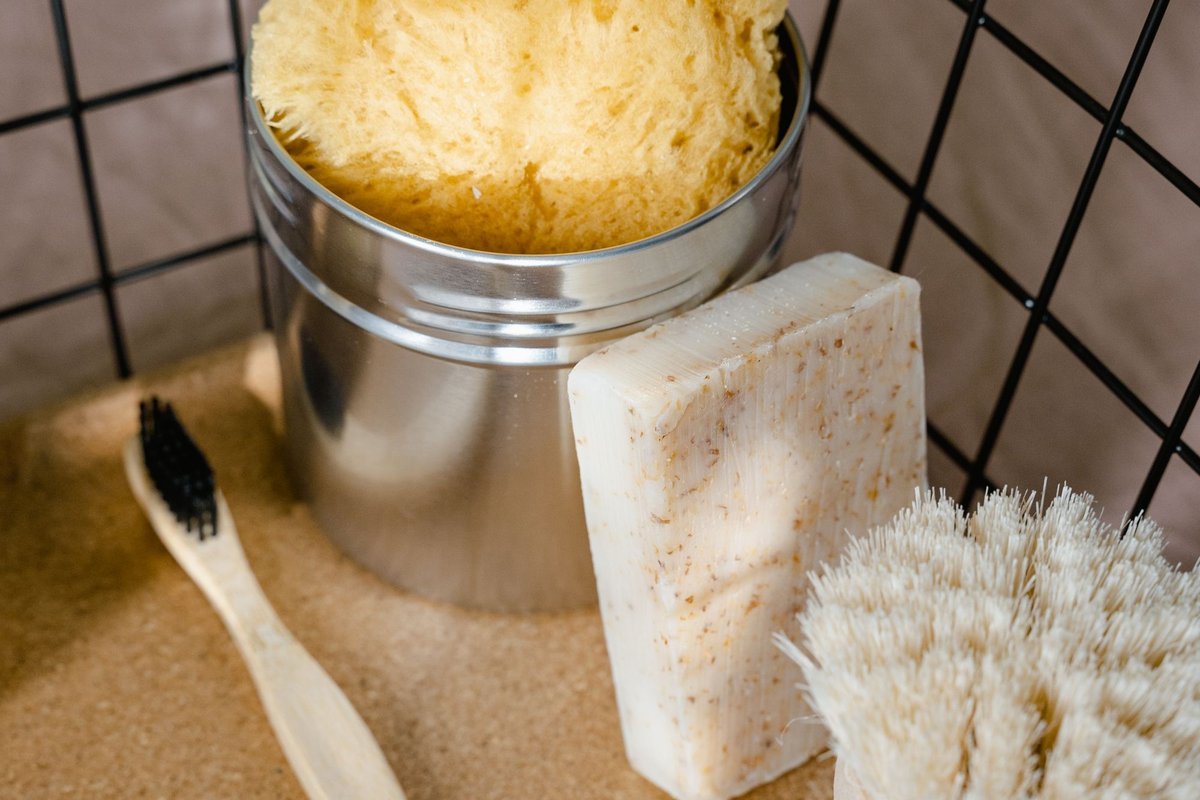 Bath sponge, soap and brushes in a metal shower caddy