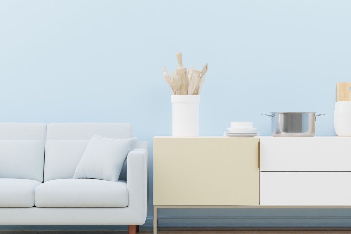 White sofa beside a white cabinet with drawers