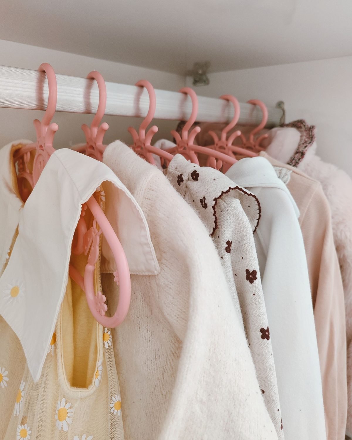 slim matching hangers holding clothes in a closet