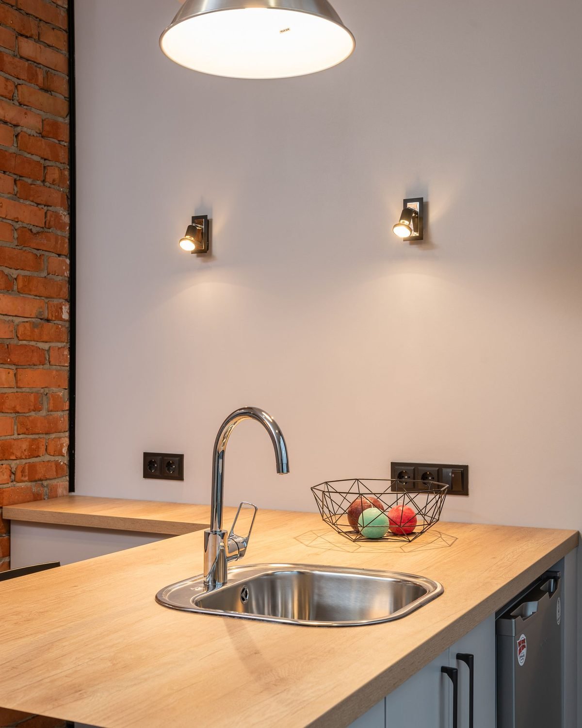 small apartment kitchen counter with a sink and wooden worktop