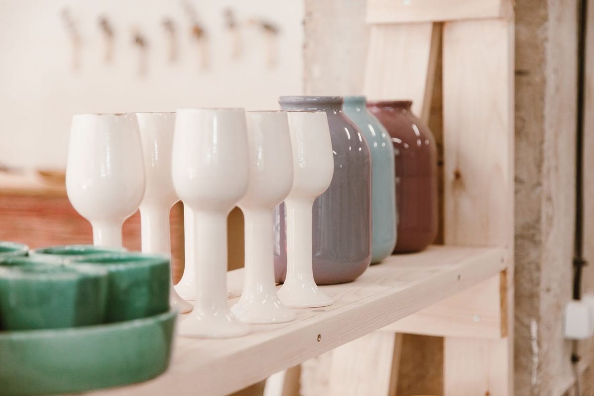 glasses, cups and jars neatly arranged on open kitchen shelves