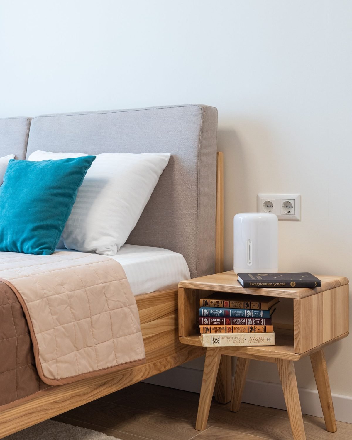 stack of books stored in a bedside table shelf