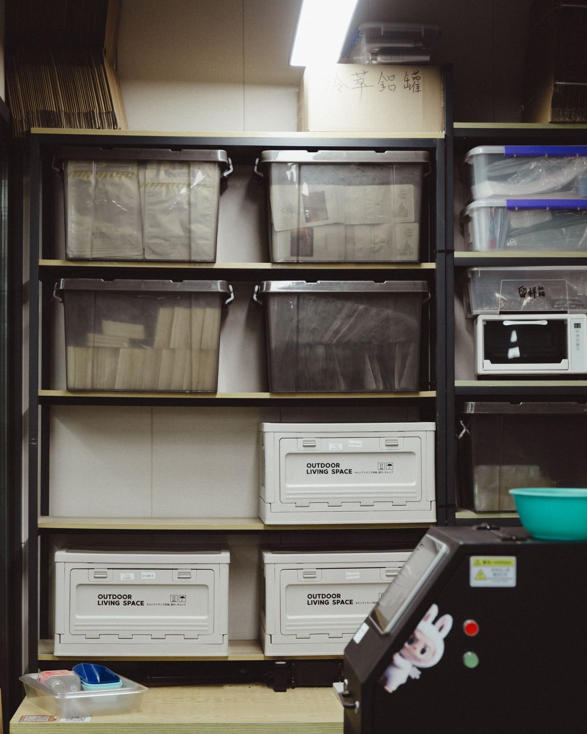 stacked clear plastic storage drawers on metal shelving