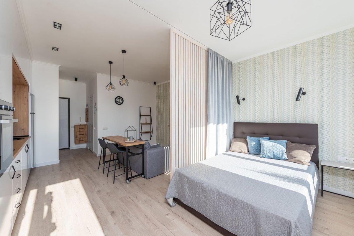 bright, tidy small studio apartment with a cozy bed