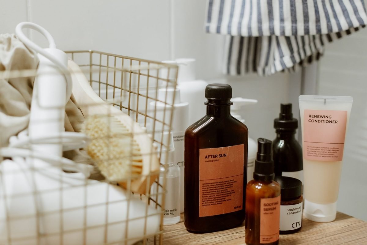 under bathroom sink organization ideas: wire basket and skincare bottles in a bathroom corner