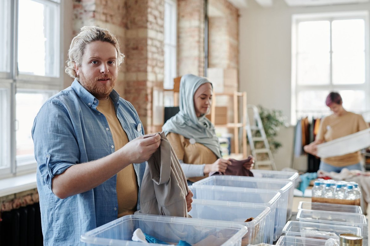 Woman sorting clothes into plastic storage containers