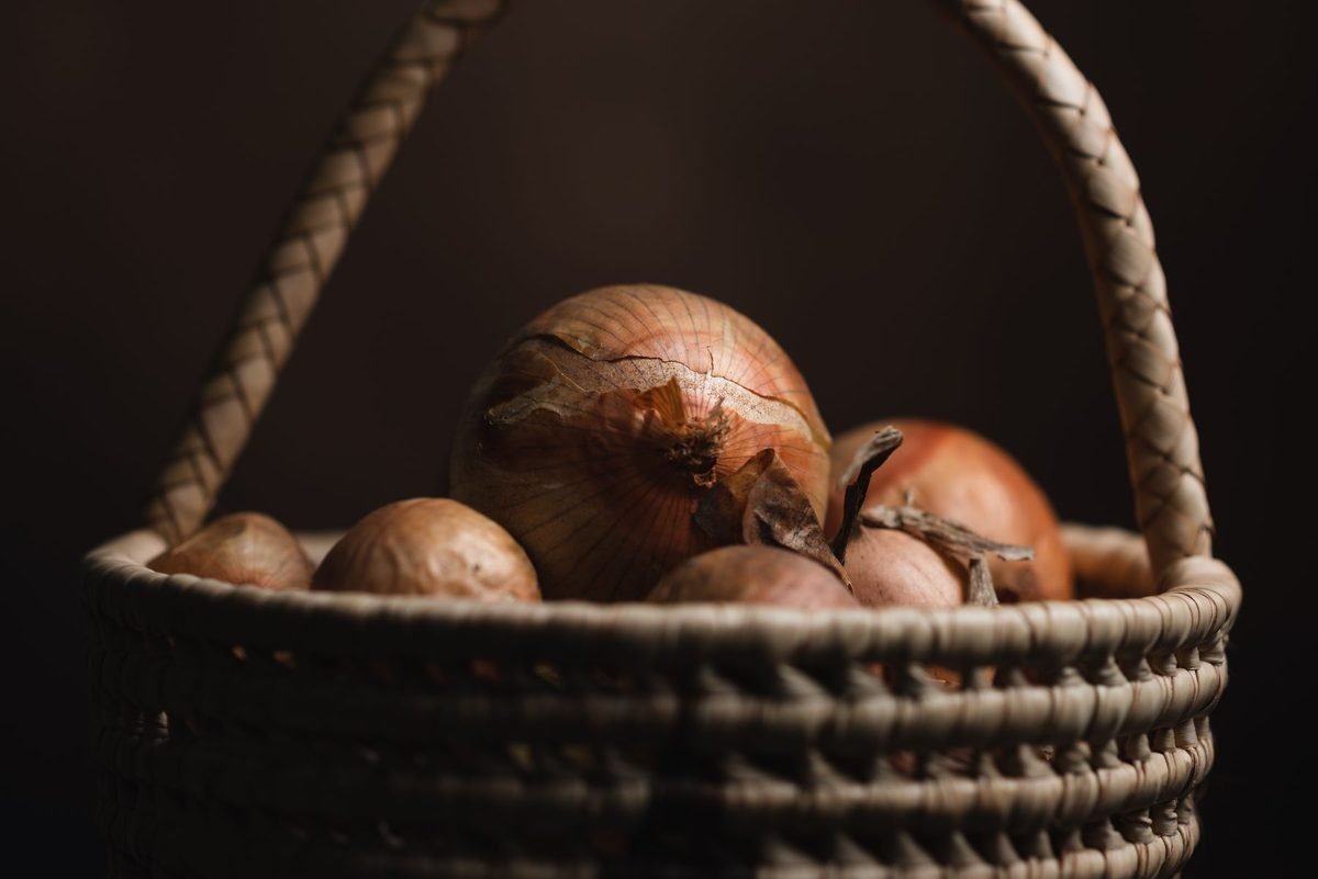 woven basket filled with onions